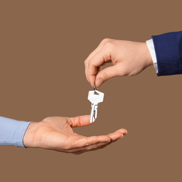 New business owner receiving keys after closing on a business purchase in Alberta