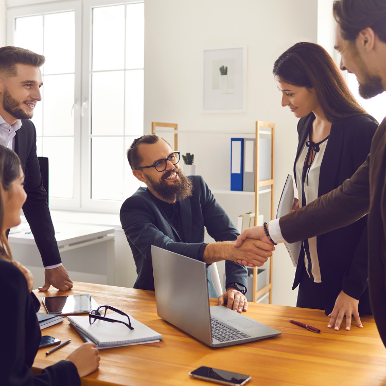 New business owner shaking hands with staff during a team introduction after taking ownership