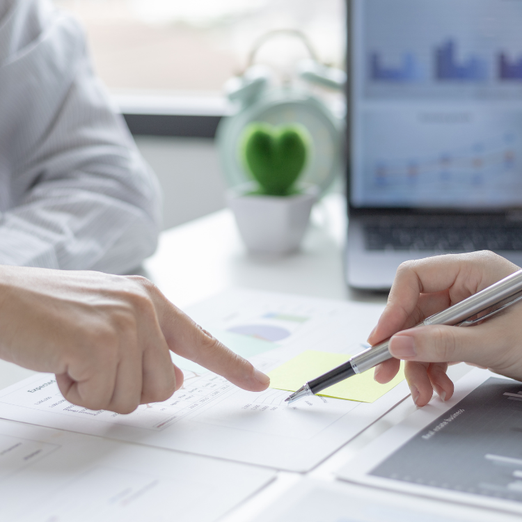 New business owner and advisor reviewing financial reports and charts during a transition period