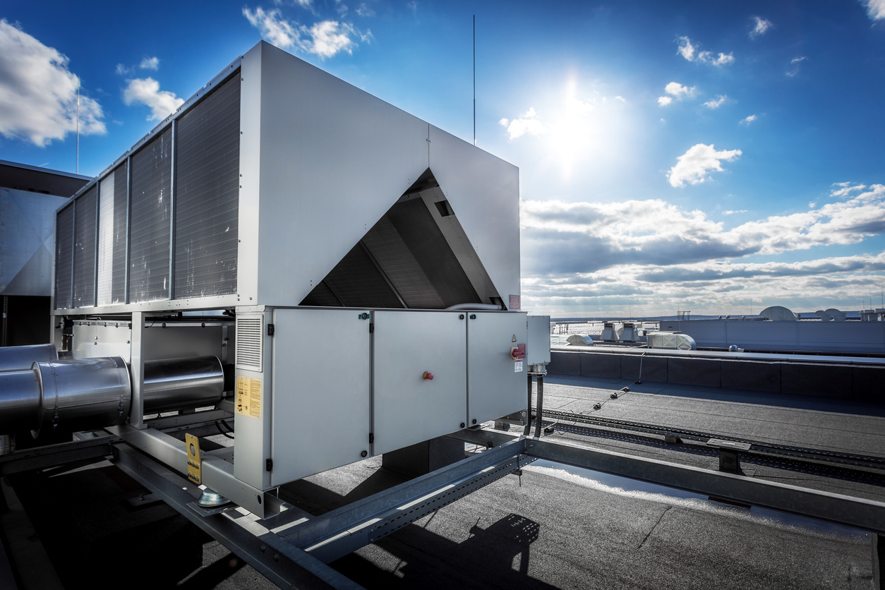 Large industrial HVAC ventilation unit on a rooftop, providing exhaust and intake air solutions for commercial buildings.