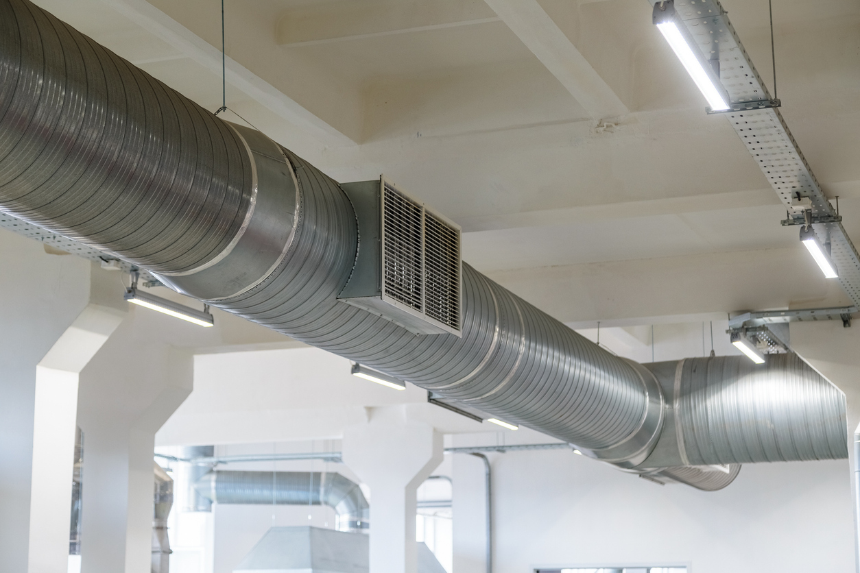 Industrial ventilation duct system inside a factory, ensuring clean air circulation and compliance with workplace safety standards.